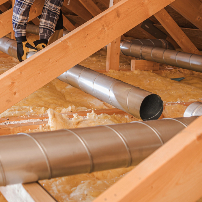 hvac technician installing an air duct