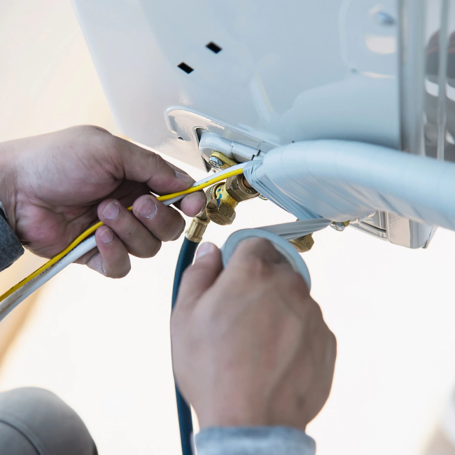 worker installing an ac heater